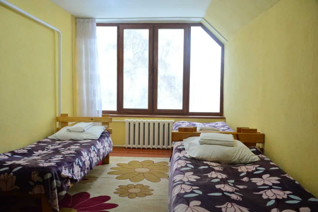 Bright triple room with prepared beds at Salamat Guesthouse